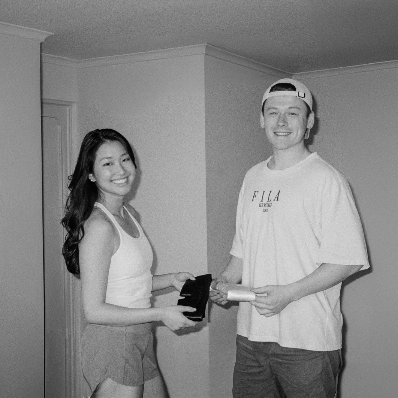 Co-founders of Silk The Label smiling while holding their first luxury silk sleep mask prototype, showcasing the beginnings of a premium silk sleep accessory brand.